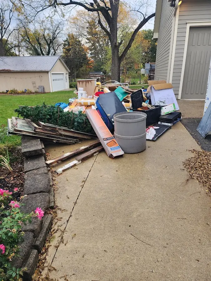Dumpster being loaded with debris for Commercial Dumpster Rental in Lake Land'Or